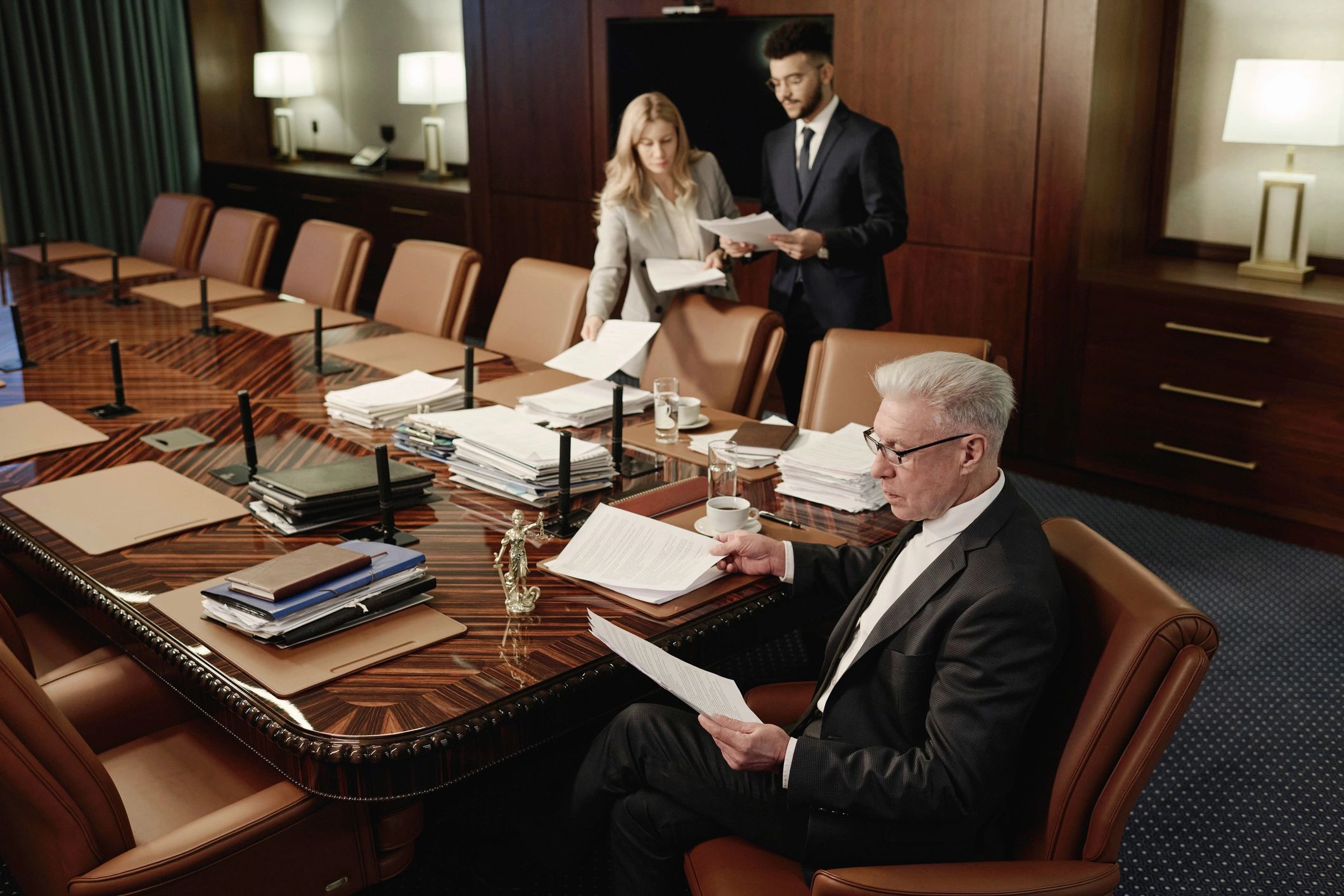 Legal professionals reviewing documents in a conference room